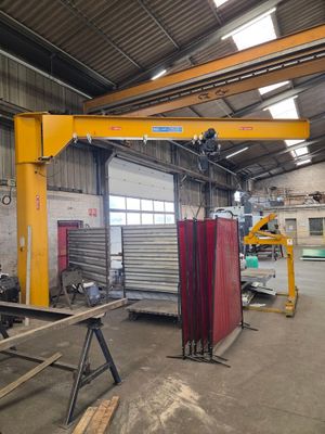 une photo d'une usine avec une grande grue au milieu