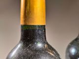 two bottles of wine sitting next to each other on a table