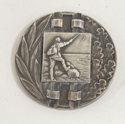 a silver medal with a picture of a man on it