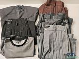 a lot of clothes that are laying out on a table