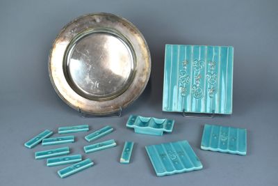 a silver plate and a silver tray with blue tiles