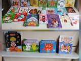 many children ' s books on the shelves in the store