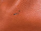 a close up view of a brown leather bag
