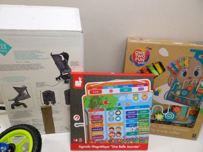 a small child ' s play set on a table next to a box of toys