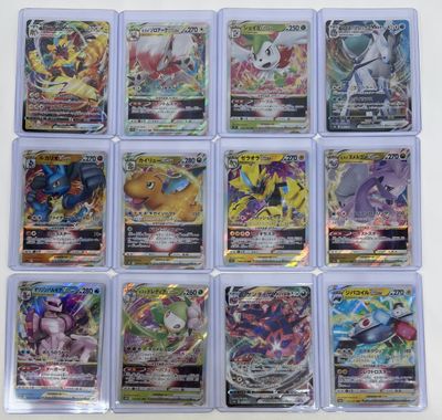 a bunch of pokemon cards in plastic cases on a table