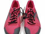 une paire de baskets roses avec des lacets noirs sur fond blanc