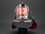 a fireman ' s helmet with the number 33 on it