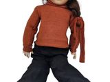 a small doll that is sitting on the ground