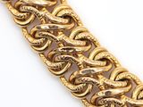 a close up of a gold chain bracelet on a white surface