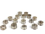 an image of a bunch of silver rings on a white surface