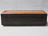 an old wooden box with a glass top on a white surface