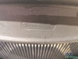 an image of a close up of a metal object with a name on it