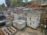 a truck that is parked next to a pile of concrete blocks