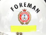 a white fireman helmet with a yellow sticker on it