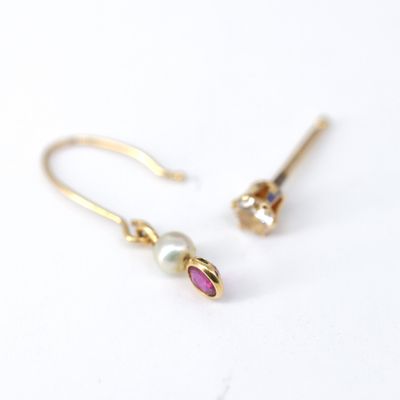 a pair of gold earrings with a pearl and a pink stone