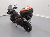 a motorcycle parked in a room with a white wall
