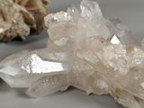 a cluster of crystals sitting on a table next to a rock
