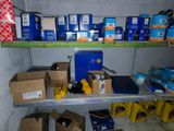 many boxes and boxes on a shelf in a room