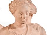 a statue of a woman holding a bird on a white background