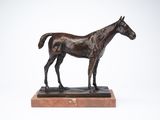 statue of a horse standing on a marble base on a white background