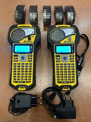two yellow and black walkie talkies sitting on top of a wooden table