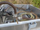 a metal container with a bunch of hoses inside of it