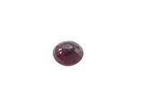 a close up of a red garnet stone on a white background