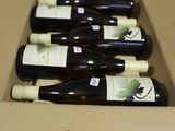 six bottles of wine in a cardboard box with a price tag