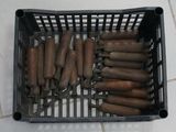 a lot of hot dogs in a basket on the floor