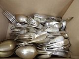 a box full of silver spoons and spoons in it