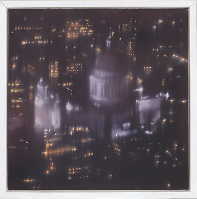 an aerial view of a city at night with buildings lit up