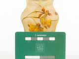 a glass vase that has a card attached to it
