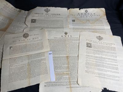 some old papers are piled on top of each other on a black surface