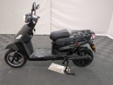 a scooter that is parked on a checkered floor
