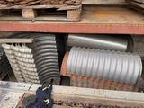 a pile of metal pipes sitting on top of a wooden table