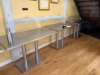 two tables that are sitting on the floor in the room