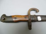 a close up of a knife with a wooden handle on a table
