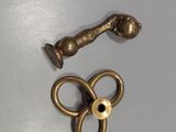 a pair of scissors and a brass object on a table