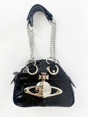 the purse is black and has a silver ring on it