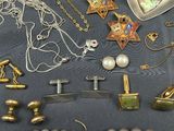 many different types of necklaces and bracelets on a table