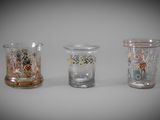 three glass vases sitting next to each other on a table