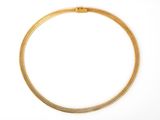 a gold necklace on a white background