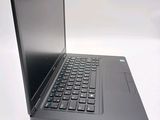 a laptop computer sitting on a table with a keyboard