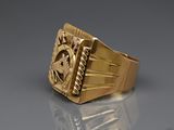 an image of a gold ring with a masonic symbol on it