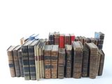 a lot of old books stacked on top of each other