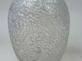 a glass vase that is sitting on a table