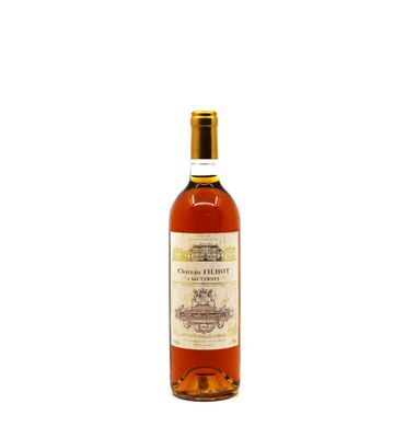 the bottle of wine is sitting on a white surface