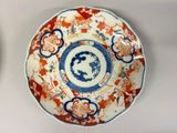 two plates with designs on them sitting on a table