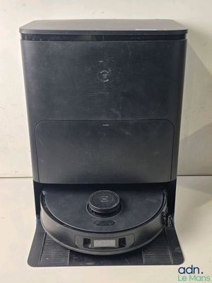 a close up of a black coffee machine on a white surface