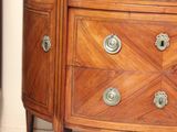 a wooden dresser with a marble top in a room